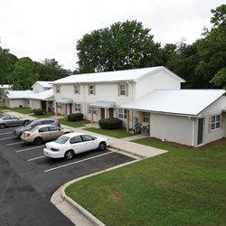 Exterior of The Savoy Apartments, located in Cartersville, GA, featuring private entrances and patios