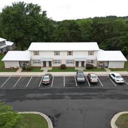 Newly painted building exterior and resurfaced parking lot with ample parking at The Savoy Apartments, located in Cartersville, GA