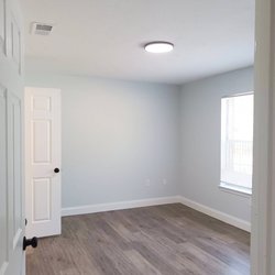Updated flooring, fresh paint, modern hardware and light fixtures in the bedroom of The Savoy Apartments, located in Cartersville, GA