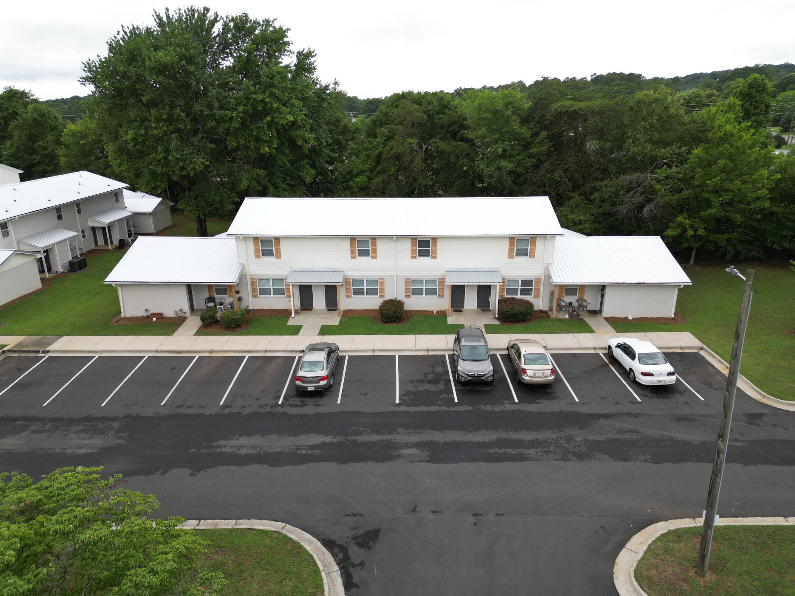 Newly painted building exterior and resurfaced parking lot with ample parking at The Savoy Apartments, located in Cartersville, GA