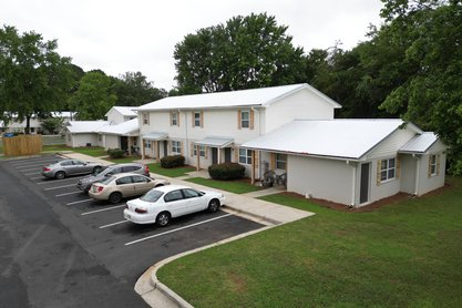 Exterior of The Savoy Apartments, located in Cartersville, GA, featuring private entrances and patios
